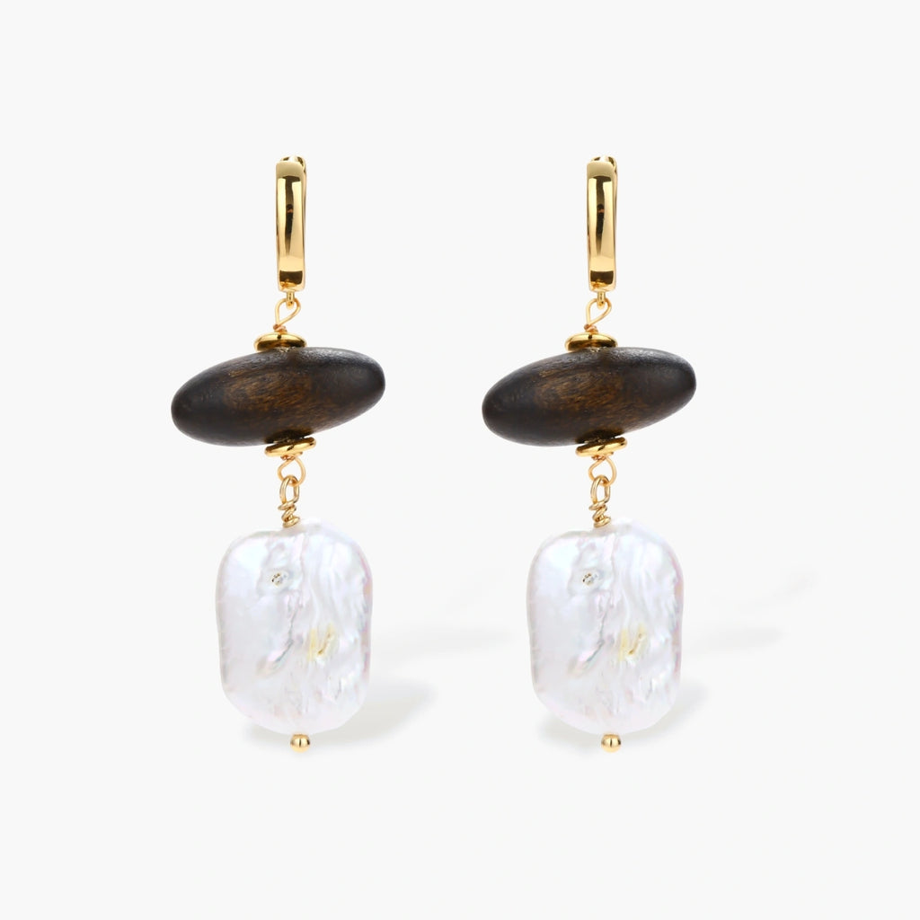 Gold hoop earrings with dark wood beads and baroque freshwater pearls, shown from multiple angles on cream background.