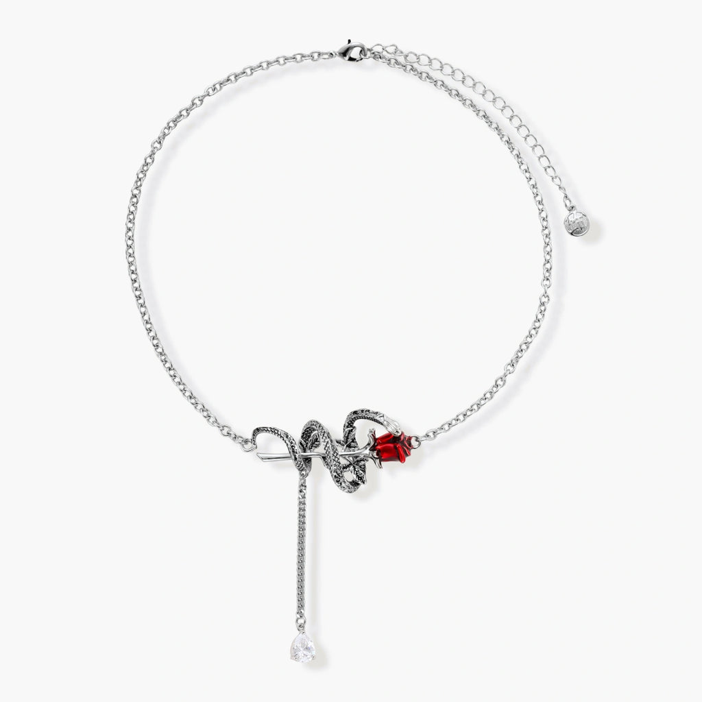 Detailed eco-brass serpent pendant necklace with red zirconia stone and crystal drop tassel on adjustable chain