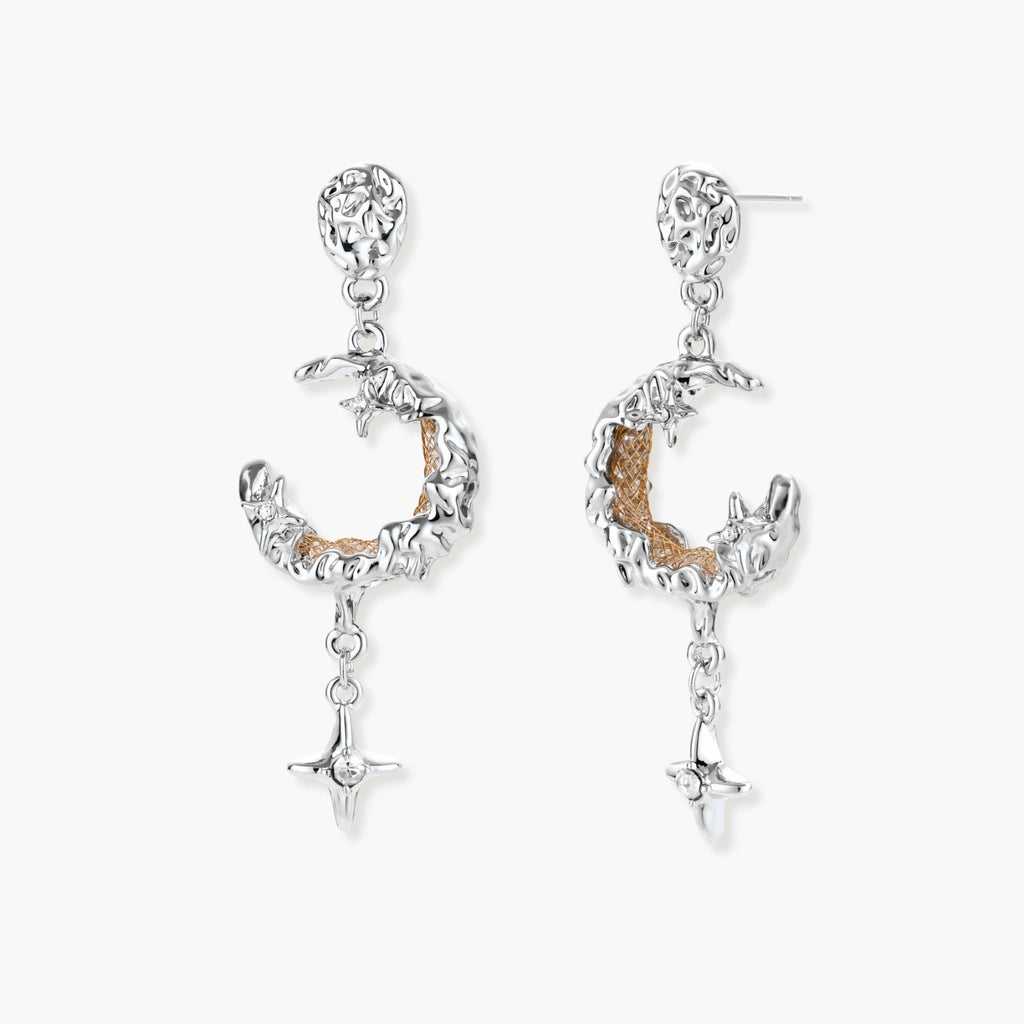 Detailed eco-brass dangle earrings featuring crescent moons with gold rope details and dangling star charms on white background.
