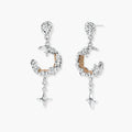 Detailed eco-brass dangle earrings featuring crescent moons with gold rope details and dangling star charms on white background.