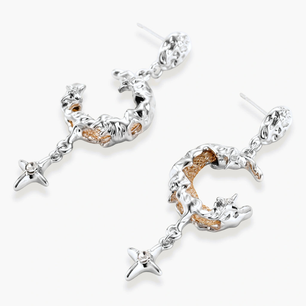 Detailed eco-brass dangle earrings featuring crescent moons with gold rope details and dangling star charms on white background.
