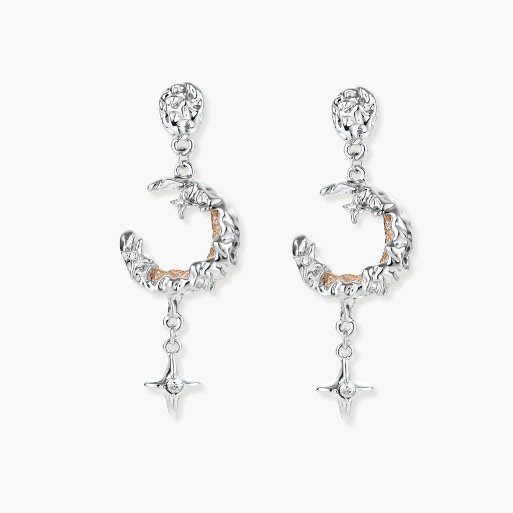 Detailed eco-brass dangle earrings featuring crescent moons with gold rope details and dangling star charms on white background.