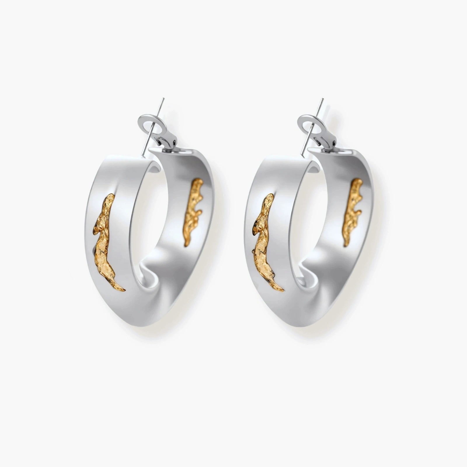 Artistic jewelry set featuring curved silver pendant with gold veining on black cord plus matching asymmetrical hoop earrings