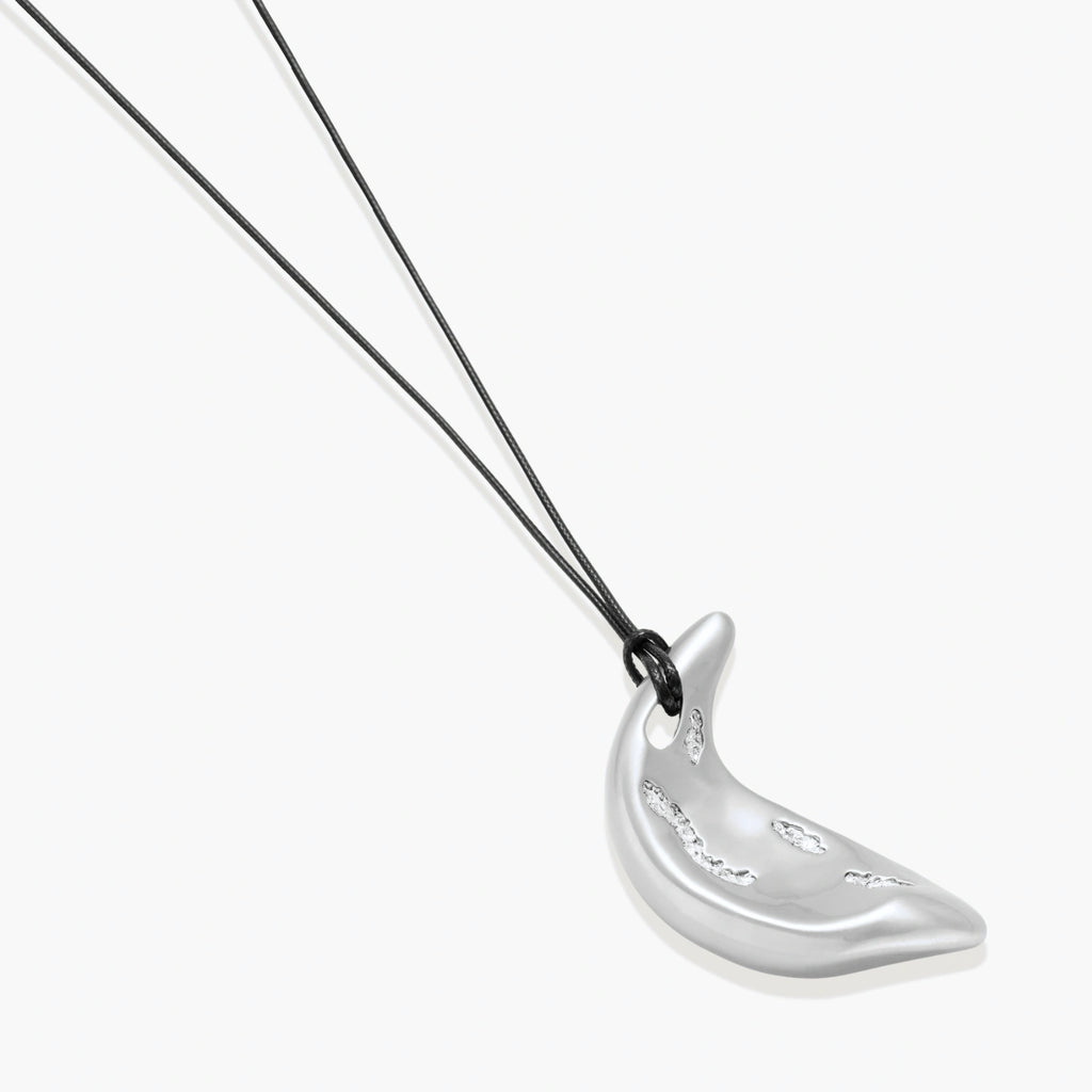 Adjustable crescent moon pendant necklace in gold and silver eco-zinc alloy with decorative engravings on black cord