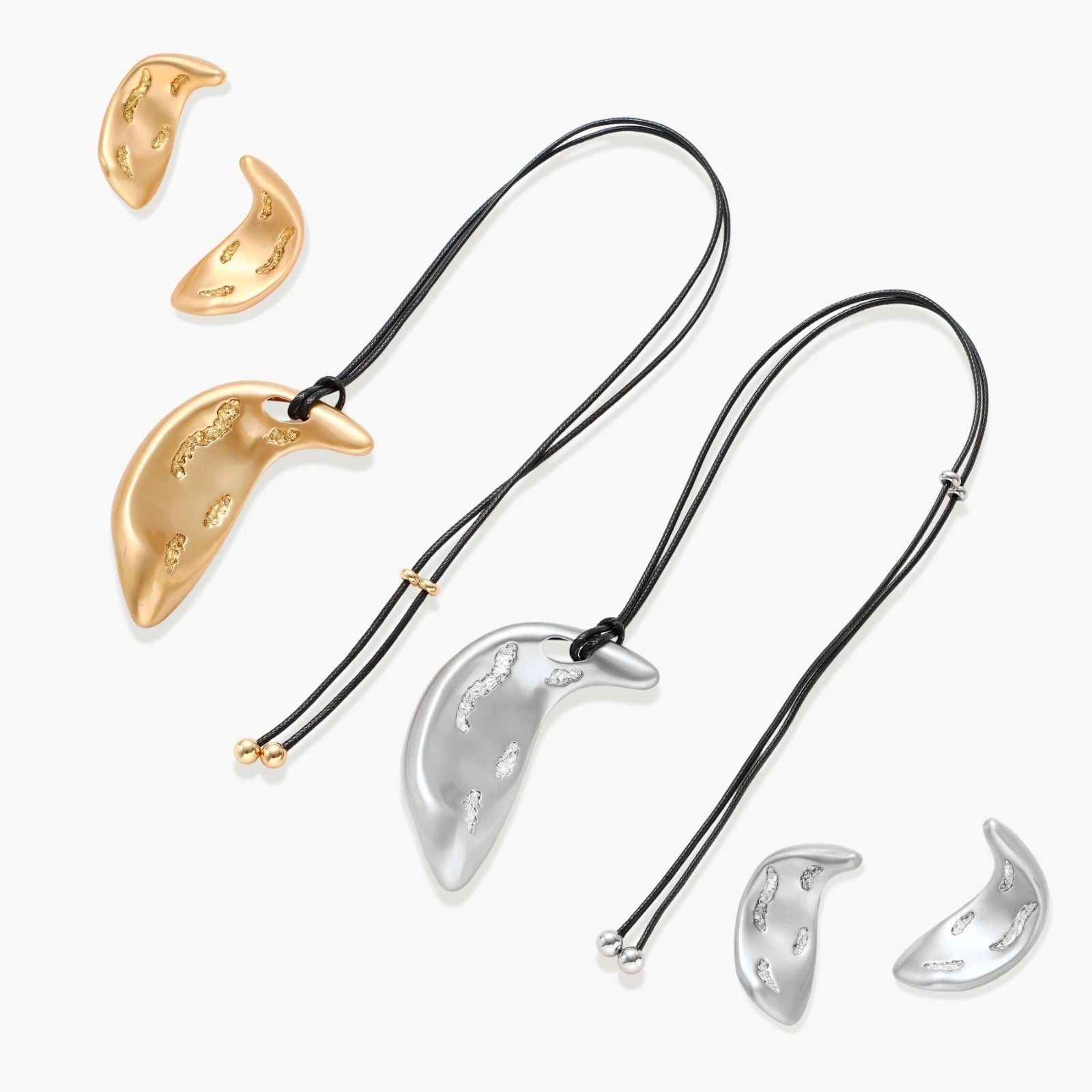 Gold-toned crescent moon pendant with textured surface on black adjustable cord, displayed with matching crescent earrings
