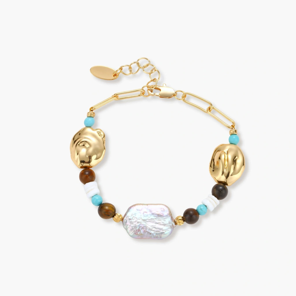 Gold-plated bracelet with baroque pearl centerpiece, turquoise and amber natural stones on adjustable chain against white background.