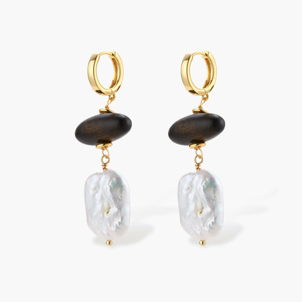 Gold hoop earrings with dark wood beads and baroque freshwater pearls, shown from multiple angles on cream background.
