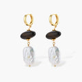 Gold hoop earrings with dark wood beads and baroque freshwater pearls, shown from multiple angles on cream background.