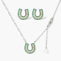 Geometric horseshoe-shaped jewelry set with radiating white zirconia center and jade-green border stones on white background.