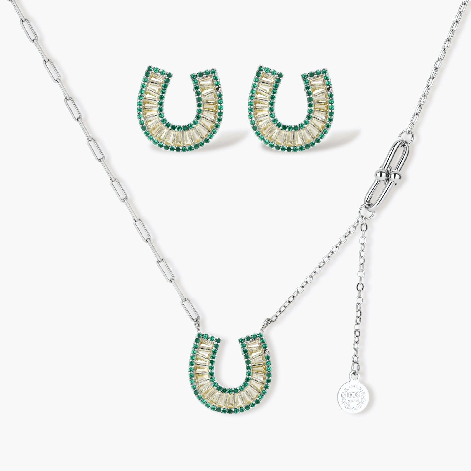 Geometric horseshoe-shaped jewelry set with radiating white zirconia center and jade-green border stones on white background.