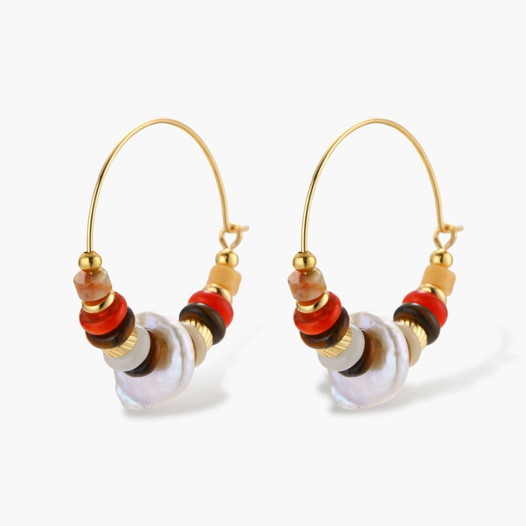 18k gold-plated earrings featuring baroque pearls and colorful natural stones in a stacked design on cream background.