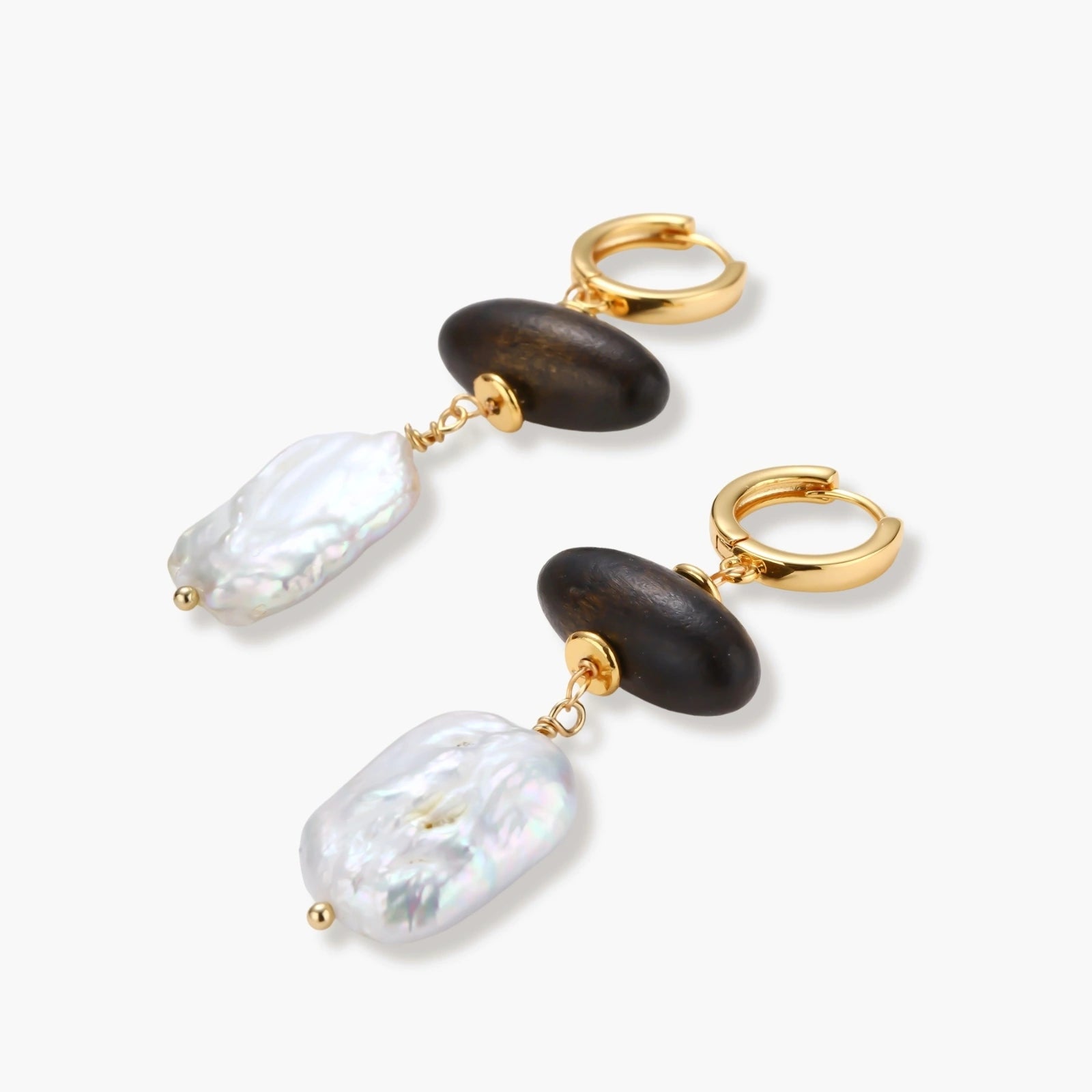 Gold hoop earrings with dark wood beads and baroque freshwater pearls, shown from multiple angles on cream background.