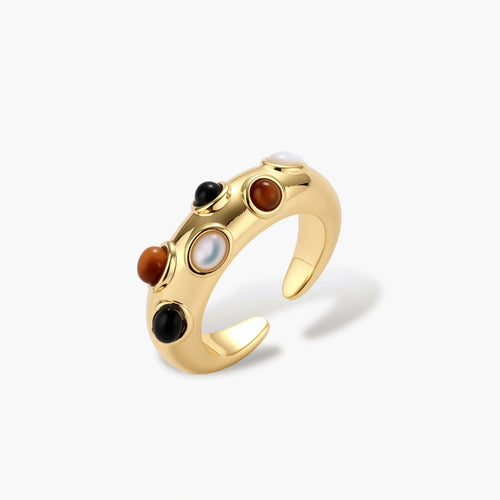 Gold-plated adjustable ring with white, amber, and black stones in organic bubble design on neutral background.